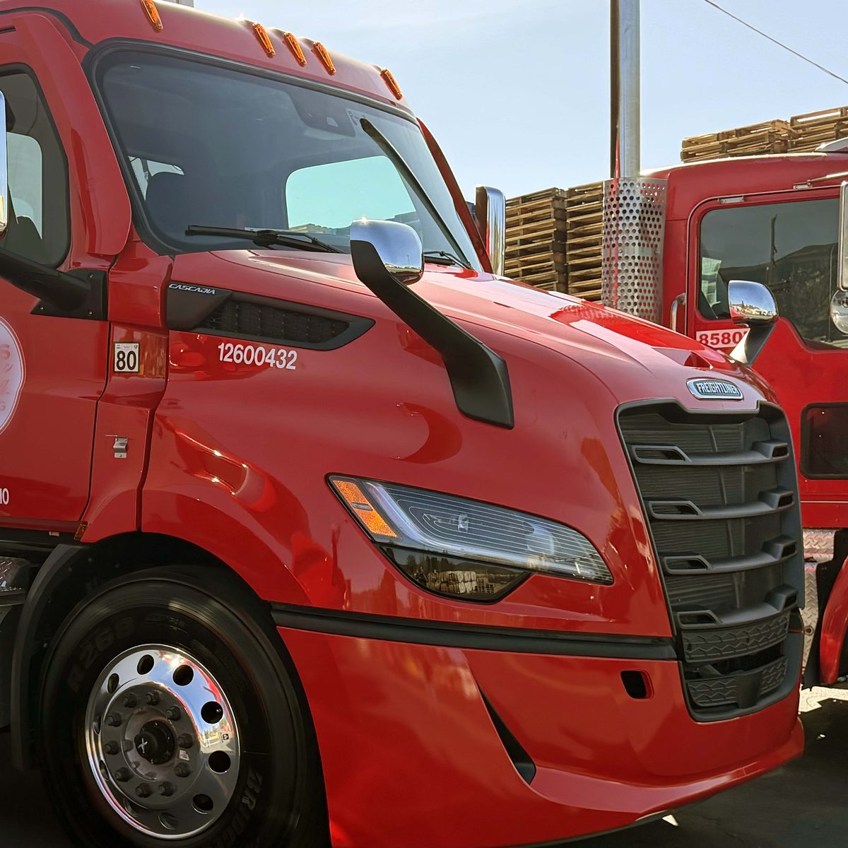 Red Freightliner Cascadia truck with glossy ceramic coated finish
